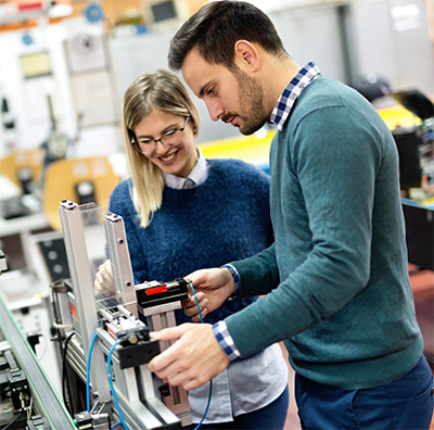 Employees working together with application equipment.